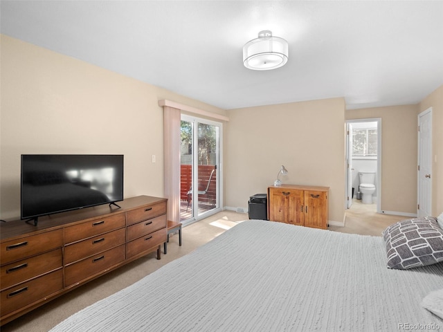 bedroom featuring light colored carpet, access to outside, and connected bathroom