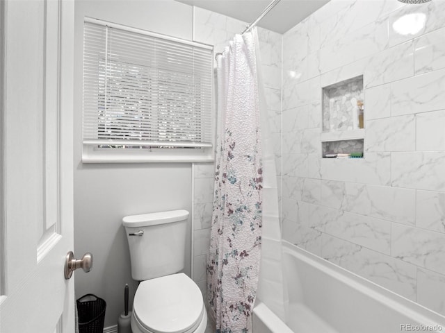 bathroom featuring shower / bath combo and toilet