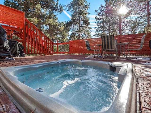 view of swimming pool with a wooden deck and an outdoor hot tub