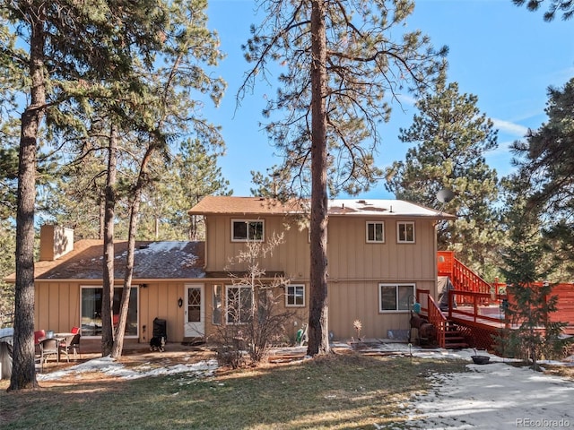 rear view of property with a lawn, a patio area, and a wooden deck