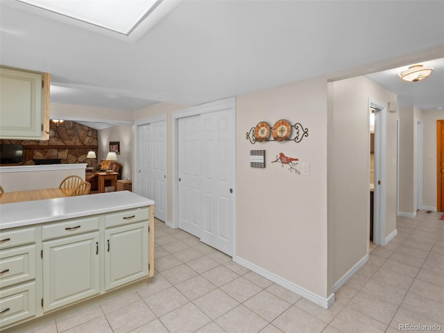 28735 Little Big Horn Dr, Evergreen, CO 80439 - kitchen with light tile patterned floors, light countertops, and baseboards