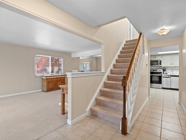 28735 Little Big Horn Dr, Evergreen, CO 80439 - staircase with baseboards and tile patterned floors
