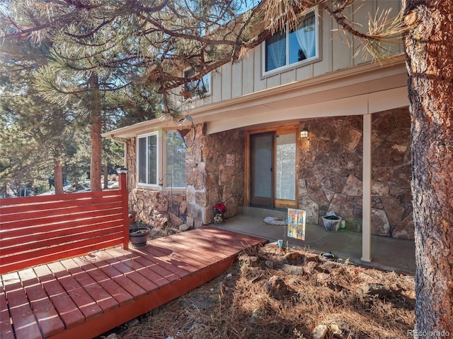 28735 Little Big Horn Dr, Evergreen, CO 80439 - doorway to property with stone siding and board and batten siding