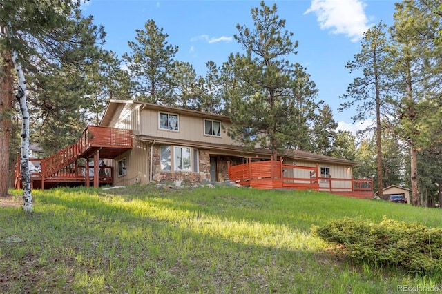 28735 Little Big Horn Dr, Evergreen, CO 80439 - rear view of house featuring a wooden deck, stairway, and stone siding