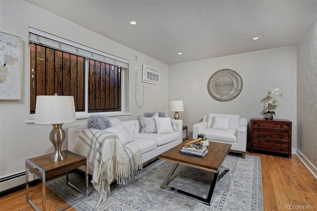 living room featuring light hardwood / wood-style flooring and an AC wall unit