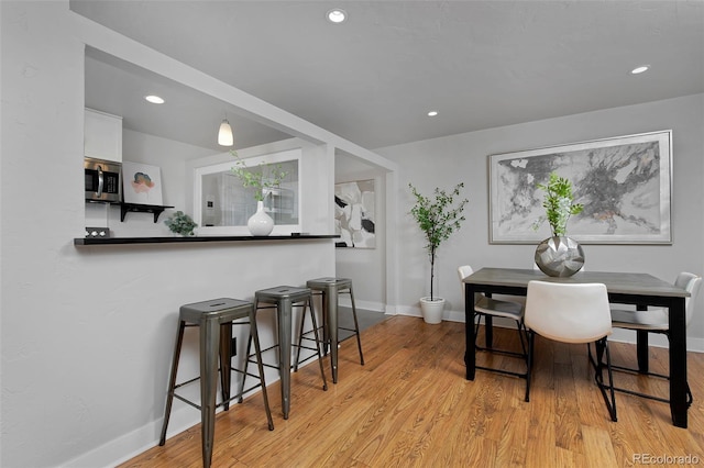 dining space featuring light wood-type flooring