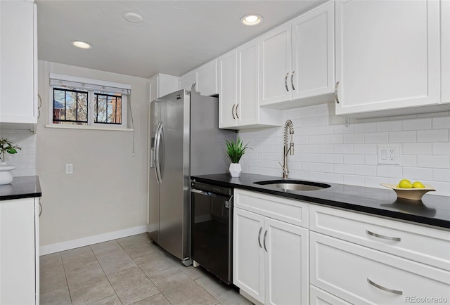 kitchen with sink, tasteful backsplash, light tile patterned floors, dishwasher, and white cabinets