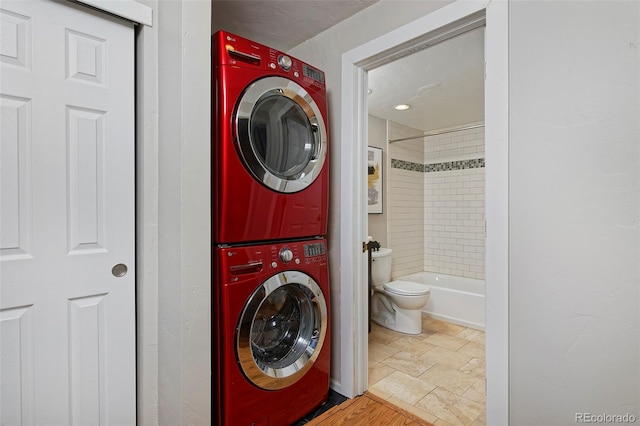 laundry area with stacked washing maching and dryer