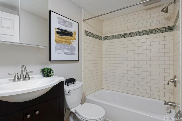 full bathroom with vanity, tiled shower / bath, and toilet