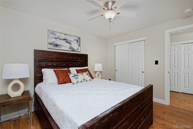 bedroom featuring hardwood / wood-style flooring, ceiling fan, and a closet