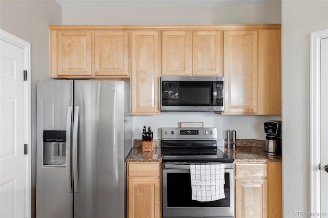 kitchen with appliances with stainless steel finishes and light brown cabinetry