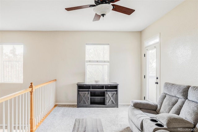 living room featuring light colored carpet and ceiling fan