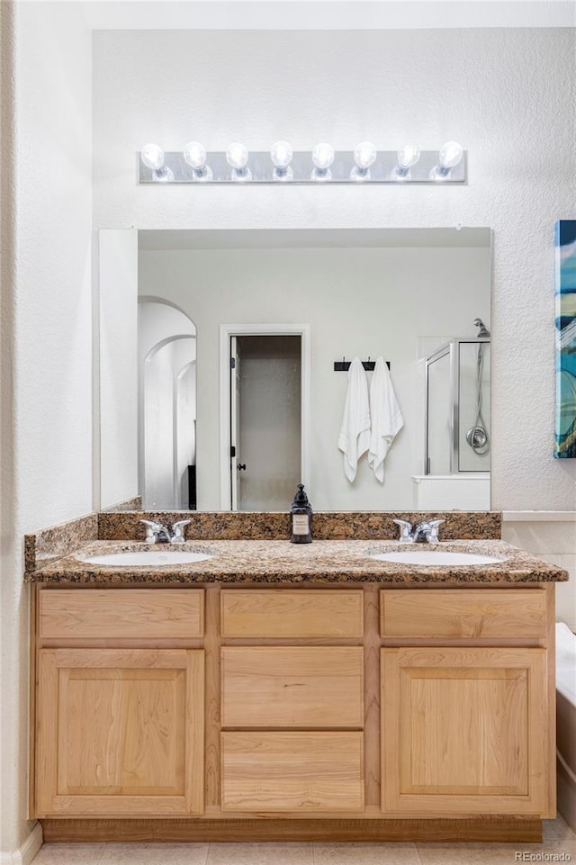 bathroom with vanity and an enclosed shower