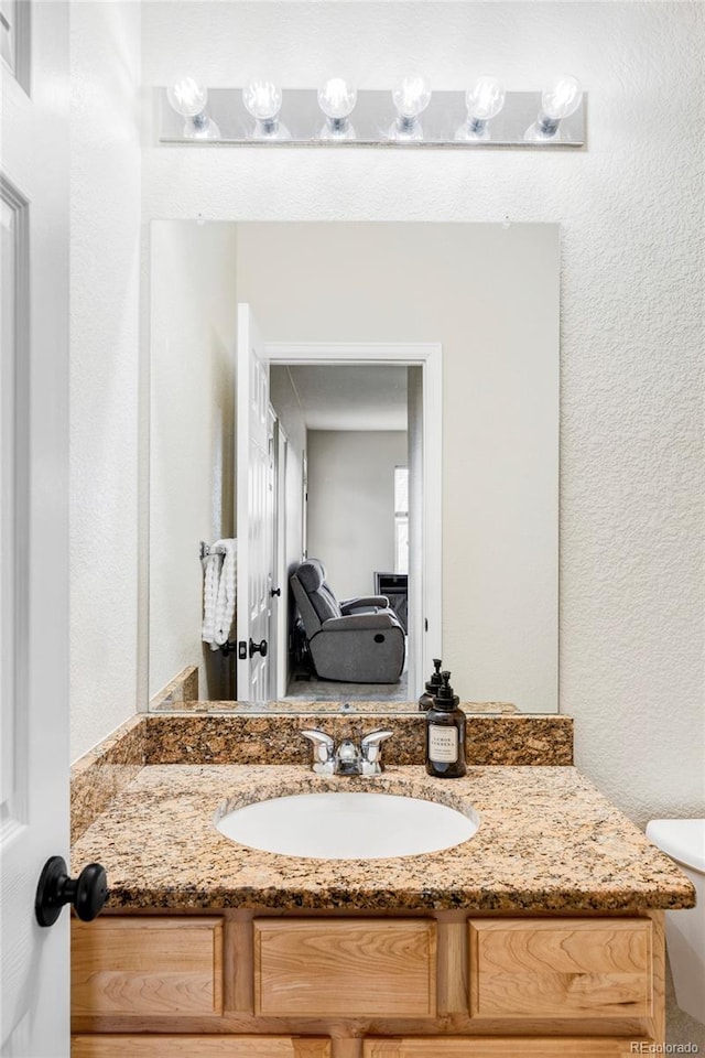 bathroom with vanity and toilet