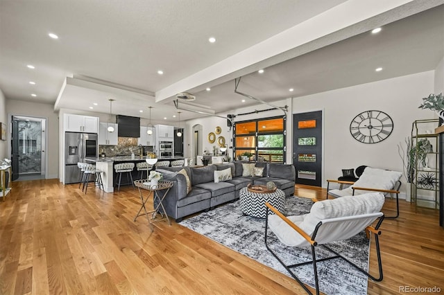 14950 W 32nd Ave, Golden, CO 80401 - living room featuring light wood-style flooring, recessed lighting, and arched walkways
