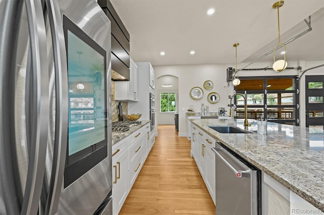 14950 W 32nd Ave, Golden, CO 80401 - kitchen featuring appliances with stainless steel finishes, white cabinetry, light wood-type flooring, and recessed lighting