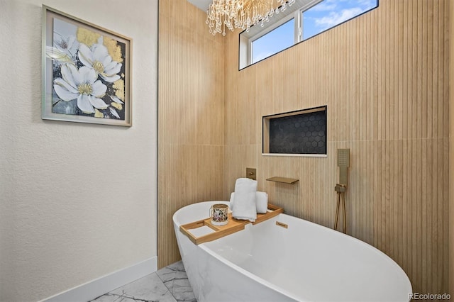14950 W 32nd Ave, Golden, CO 80401 - full bathroom with a freestanding tub, marble look tiles, and a chandelier