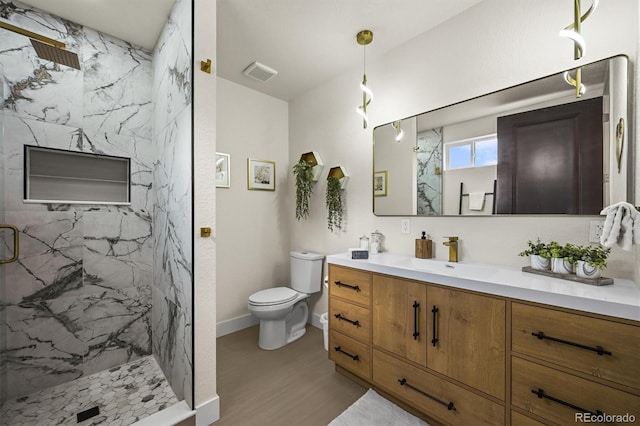 14950 W 32nd Ave, Golden, CO 80401 - bathroom featuring vanity, a marble finish shower, and wood finished floors