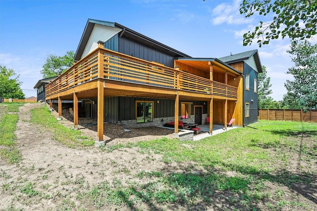 14950 W 32nd Ave, Golden, CO 80401 - rear view of house with board and batten siding and a deck