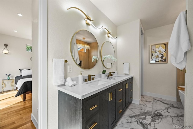 14950 W 32nd Ave, Golden, CO 80401 - bathroom with ensuite bathroom, double vanity, a tub, marble finish floors, and recessed lighting