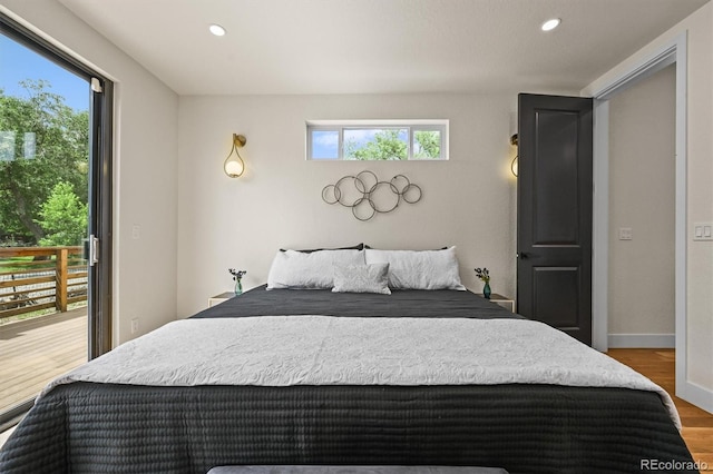 14950 W 32nd Ave, Golden, CO 80401 - bedroom with multiple windows, wood finished floors, recessed lighting, and access to exterior