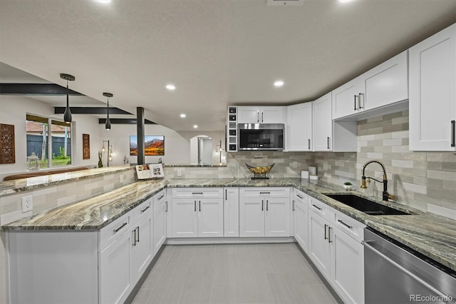 14950 W 32nd Ave, Golden, CO 80401 - kitchen featuring appliances with stainless steel finishes, a peninsula, white cabinets, decorative backsplash, and recessed lighting