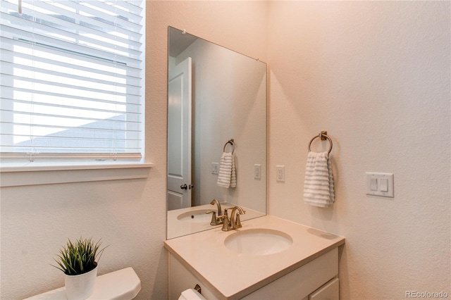 bathroom featuring vanity and toilet