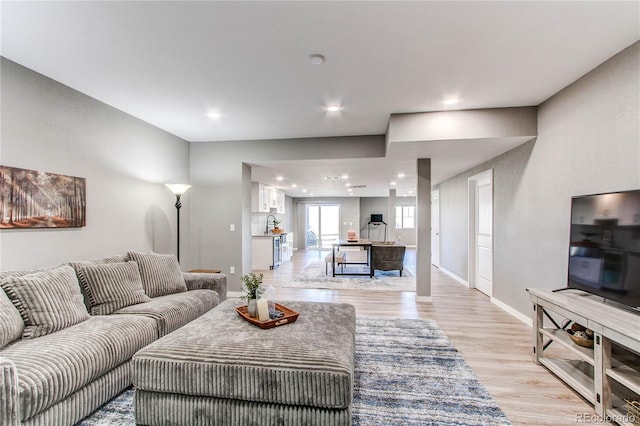 living room with light hardwood / wood-style flooring