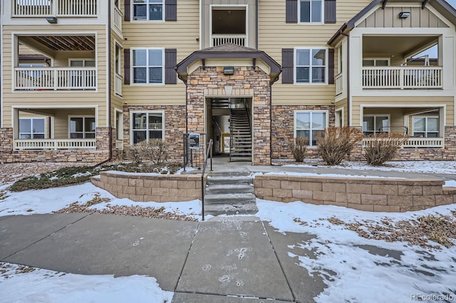 view of snow covered property entrance