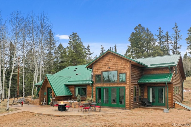34 Nebraska Cir, Florissant, CO 80816 - rear view of house featuring a patio, metal roof, and french doors