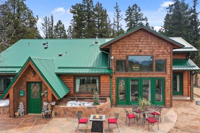 34 Nebraska Cir, Florissant, CO 80816 - rear view of house featuring a patio, an outdoor fire pit, and metal roof