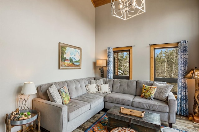 34 Nebraska Cir, Florissant, CO 80816 - living area featuring high vaulted ceiling, wood finished floors, and a chandelier