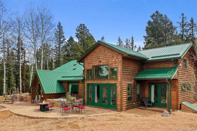 34 Nebraska Cir, Florissant, CO 80816 - back of property featuring a patio, metal roof, and french doors