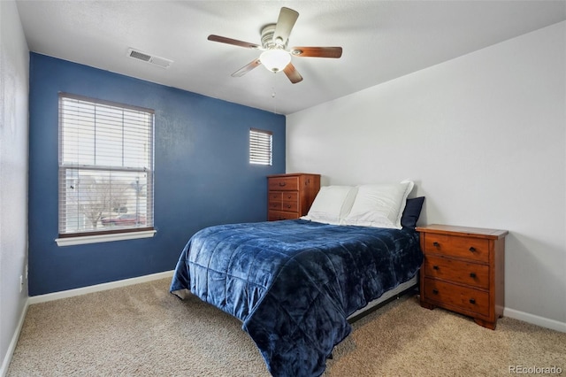 bedroom with light carpet, baseboards, visible vents, and ceiling fan