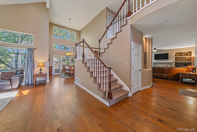 10421 Kennemere Ln, Parker, CO 80134 - foyer featuring a high ceiling, stairway, hardwood / wood-style floors, a chandelier, and a ceiling fan