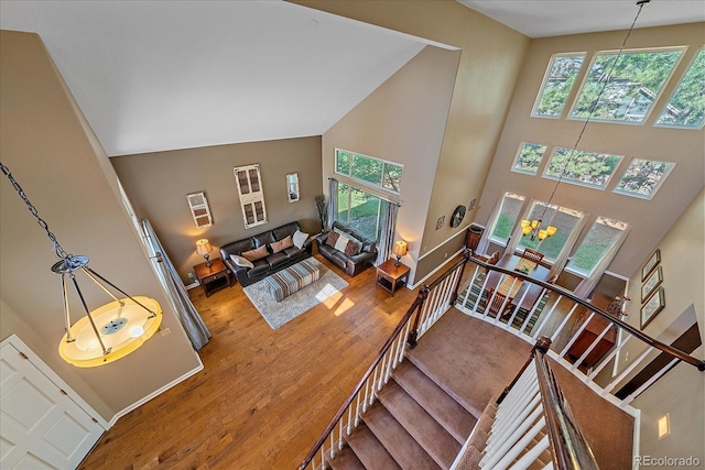 10421 Kennemere Ln, Parker, CO 80134 - stairs featuring a towering ceiling, healthy amount of natural light, wood finished floors, and a chandelier