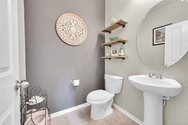 bathroom with sink, tile patterned floors, and toilet