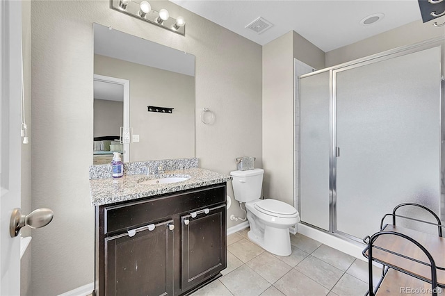 bathroom featuring toilet, vanity, tile patterned floors, and walk in shower