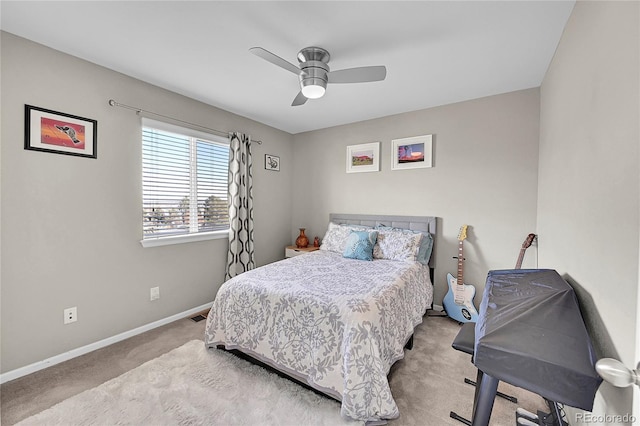 bedroom with ceiling fan and light carpet