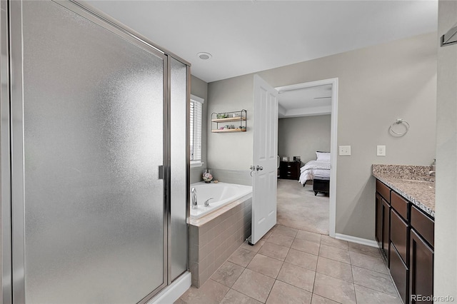 bathroom featuring tile patterned floors, shower with separate bathtub, and vanity