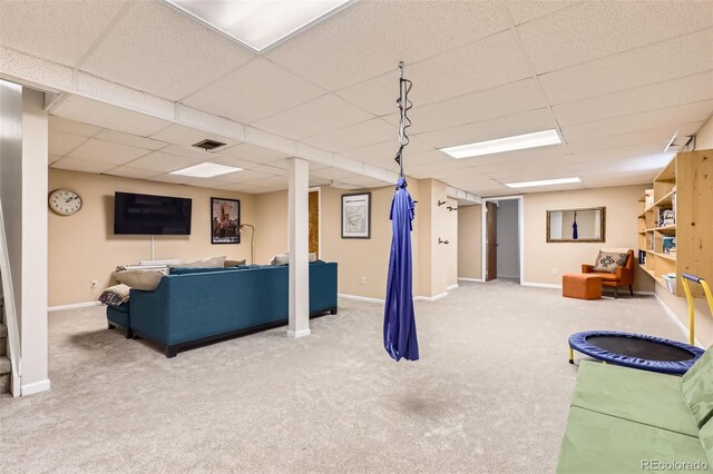 carpeted living room with visible vents, baseboards, and a paneled ceiling