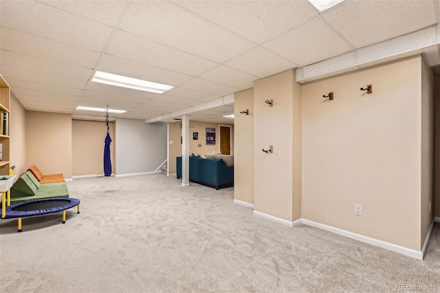 rec room with baseboards, a drop ceiling, and carpet