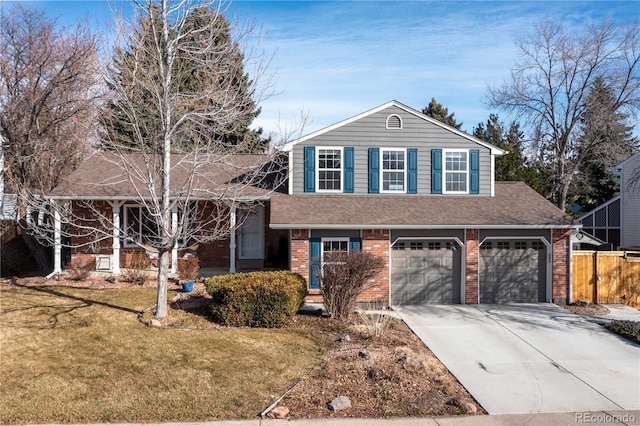 split level home featuring driveway, fence, roof with shingles, a front yard, and brick siding