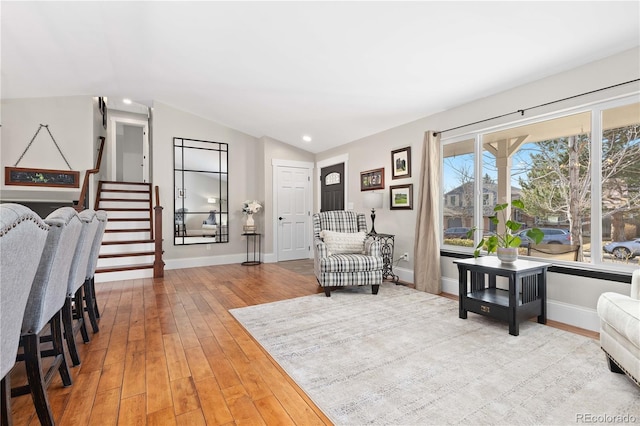 sitting room featuring lofted ceiling, hardwood / wood-style flooring, recessed lighting, baseboards, and stairs