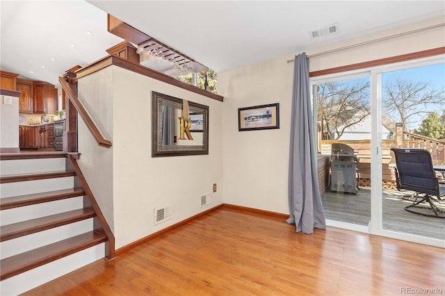 interior space featuring visible vents, baseboards, and wood finished floors