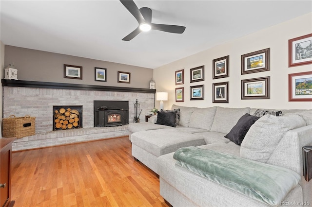 living room featuring ceiling fan and light wood finished floors