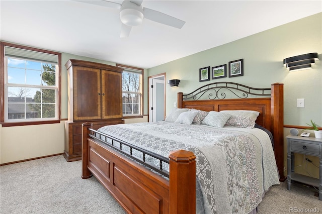 bedroom featuring baseboards, light carpet, and a ceiling fan