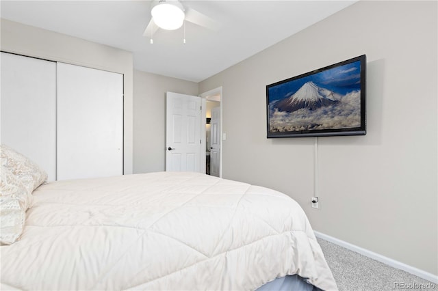 bedroom featuring a closet, baseboards, carpet, and a ceiling fan