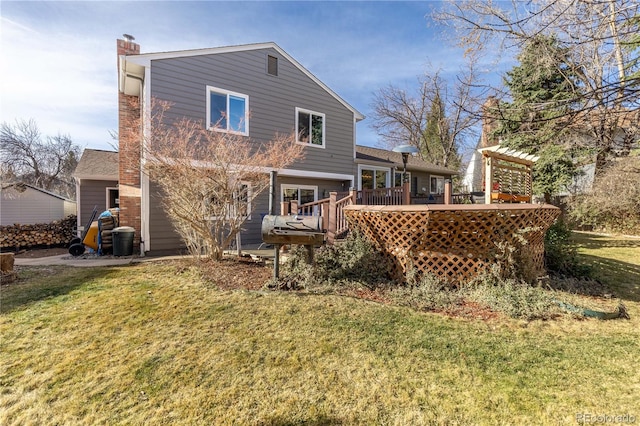 back of house featuring a wooden deck, a lawn, and a chimney