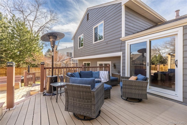 wooden deck featuring an outdoor living space and fence